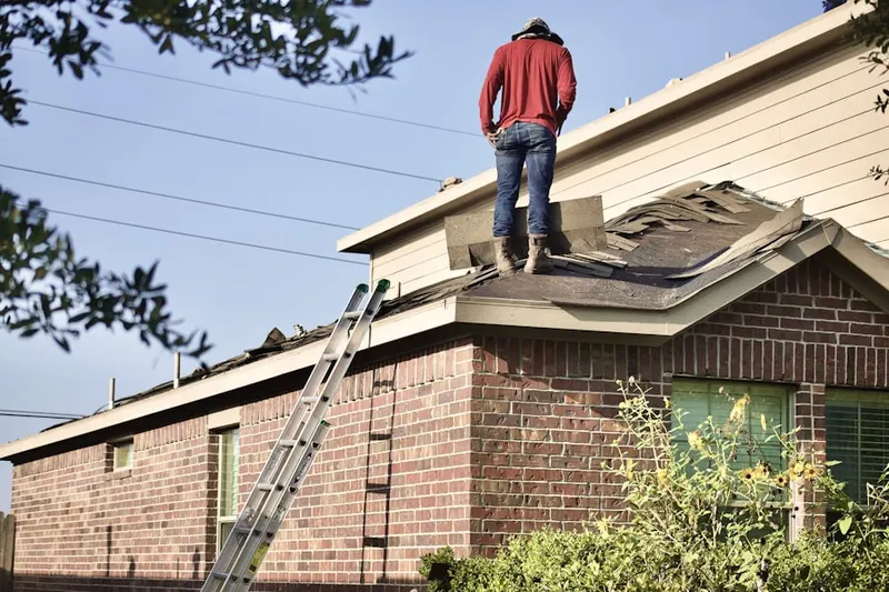 Professional roofer working on a residential roof in Revolutionary Farm